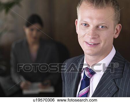 Business man and woman in office View Large Photo Image Stock Photograph - Business man and woman in office. Fotosearch