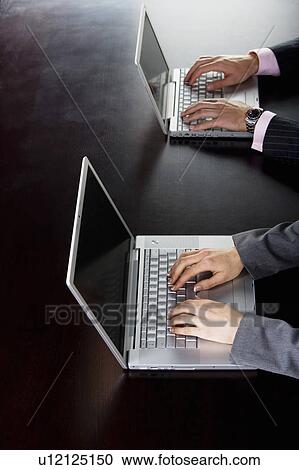 Business man and woman on computers View Large Photo Image Stock Image - Business man and woman on computers. Fotosearch