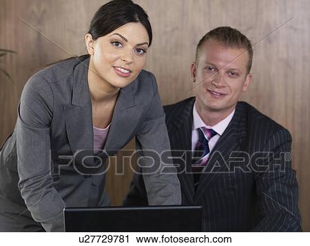 Business man and woman working in office View Large Photo Image Stock Image - Business man and woman working in office. Fotosearch