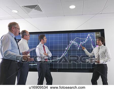 Picture - Business meeting with graphs on screen. Fotosearch