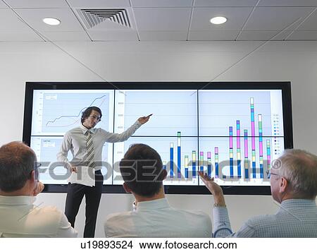 Picture - Business meeting with graphs on screen. Fotosearch