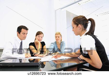 Business team look at plans View Large Photo Image Stock Image - Business team look at plans. Fotosearch