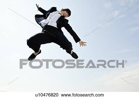 Stock Image - Business woman celebrating. Fotosearch