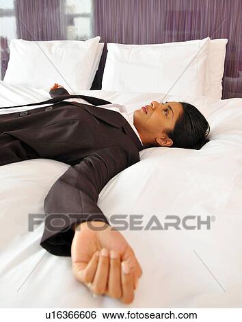 Business woman chills out on bed View Large Photo Image Stock Photograph - Business woman chills out on bed. Fotosearch