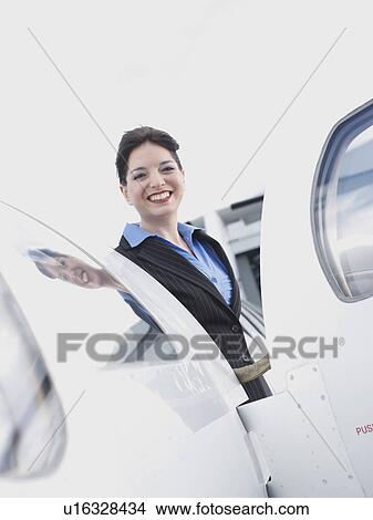 Picture - Business woman on corporate jet. Fotosearch