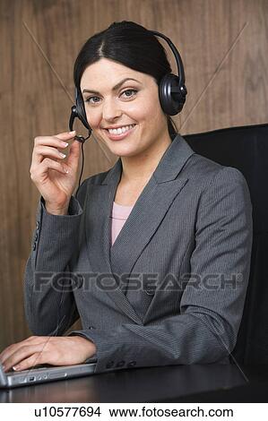 Business woman on telephone headset View Large Photo Image Picture - Business woman on telephone headset. Fotosearch