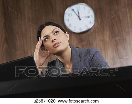 Business woman sitting at desk thinking View Large Photo Image Stock Image - Business woman sitting at desk thinking. Fotosearch