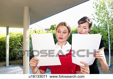 Stock Image - Business women read data. Fotosearch