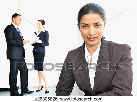 Business women with colleagues in office View Large Photo Image Stock Photograph - Business women with colleagues in office. Fotosearch
