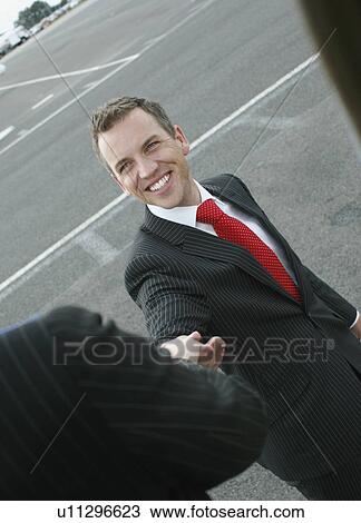 Businessman giving helping hand View Large Photo Image Stock Image - Businessman giving helping hand. Fotosearch