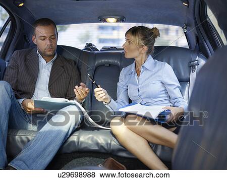Businessman signing paper in limousine View Large Photo Image Stock Photo - Businessman signing paper in limousine. Fotosearch