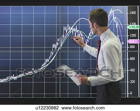 Businessman with graph on screen View Large Photo Image Stock Image - Businessman with graph on screen. Fotosearch