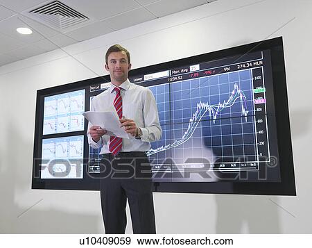Businessman with graph on screen View Large Photo Image Stock Photo - Businessman with graph on screen. Fotosearch