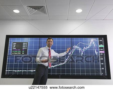 Stock Photography - Businessman with graph on screen. Fotosearch