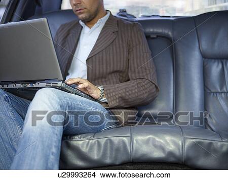 Businessman with laptop in limousine View Large Photo Image Picture - Businessman with laptop in limousine. Fotosearch