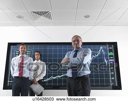 Businessmen in front of graphs on screen View Large Photo Image Stock Image - Businessmen in front of graphs on screen. Fotosearch