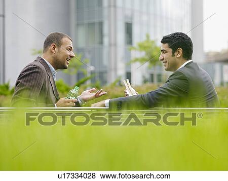 Stock Photo - Businesspeople eating outdoors. Fotosearch