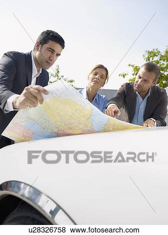 Businesspeople looking at map View Large Photo Image Stock Photo - Businesspeople looking at map. Fotosearch