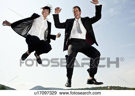 Businesswoman and businessman jumping View Large Photo Image Stock Photo - Businesswoman and businessman jumping. Fotosearch