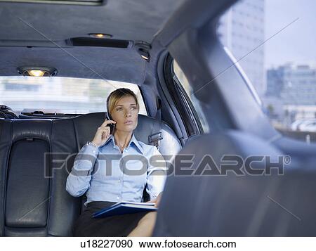 Businesswoman with phone in limousine View Large Photo Image Stock Image - Businesswoman with phone in limousine. Fotosearch