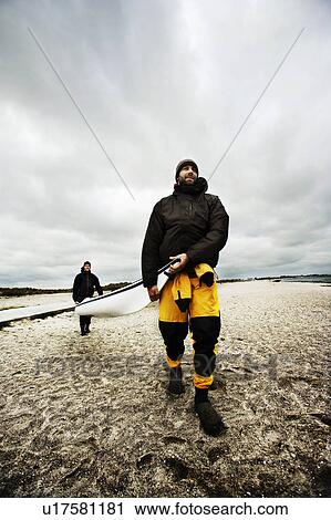 Stock Image - Carrying Kayak. Fotosearch
