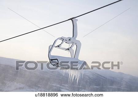 Stock Photograph - Chair lift full of snow and ice. Fotosearch