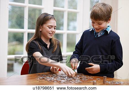Children counting piles of coins View Large Photo Image Stock Image - Children counting piles of coins. Fotosearch