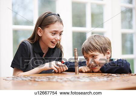 Children counting piles of money View Large Photo Image Picture - Children counting piles of money. Fotosearch
