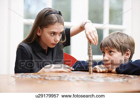 Children counting piles of money View Large Photo Image Stock Photo - Children counting piles of money. Fotosearch