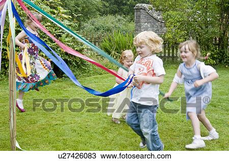 Children dancing round a maypole View Large Photo Image Stock Image - Children dancing round a maypole. Fotosearch