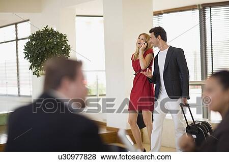 Couple arriving at the hotel View Large Photo Image Stock Photo - Couple arriving at the hotel. Fotosearch