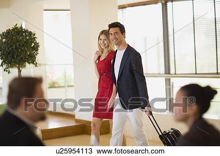 Couple arriving in hotel View Large Photo Image Stock Image - Couple arriving in hotel. Fotosearch