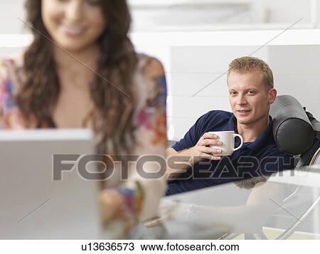 Couple at home relaxed, shopping online View Large Photo Image Stock Image - Couple at home relaxed, shopping online. Fotosearch