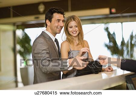 Couple checking in View Large Photo Image Stock Photography - Couple checking in. Fotosearch
