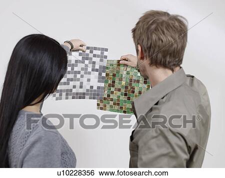 Couple choosing between tiles View Large Photo Image Stock Photograph - Couple choosing between tiles. Fotosearch