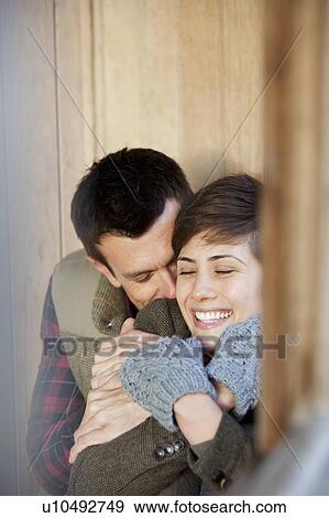 Stock Photo - Couple cuddling in a hut in a park. Fotosearch