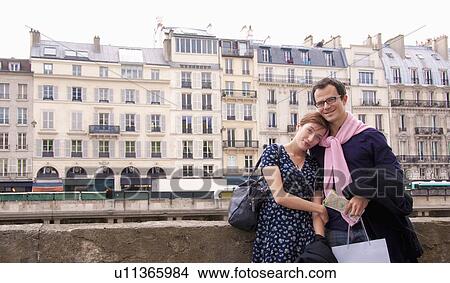 Picture - Couple embrace after shopping in Paris. Fotosearch