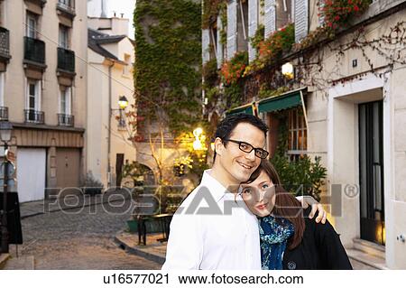 Stock Image - Couple embrace in monmartre Paris. Fotosearch