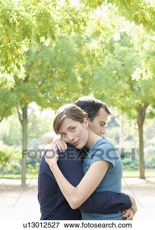 Stock Photo - Couple embrace in Paris. Fotosearch