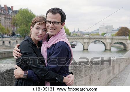 Couple embrace on banks of the Seine View Large Photo Image Stock Image - Couple embrace on banks of the Seine. Fotosearch