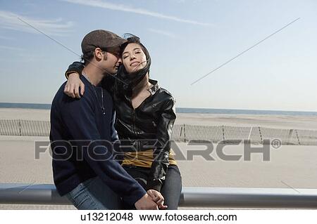 Stock Photo - Couple embracing at the beach. Fotosearch