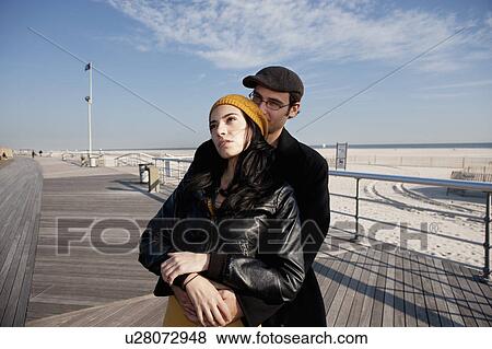 Stock Photo - Couple embracing at the beach. Fotosearch