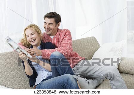 Couple fighting for newspaper View Large Photo Image Stock Photograph - Couple fighting for newspaper. Fotosearch