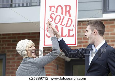 Couple high five in front of apartment View Large Photo Image Stock Image - Couple high five in front of apartment. Fotosearch