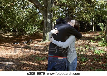 Couple hugging in park View Large Photo Image Stock Photo - Couple hugging in park. Fotosearch