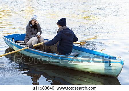 Couple in row boat having fun View Large Photo Image Stock Photograph - Couple in row boat having fun. Fotosearch