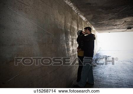 Couple kissing in tunnel View Large Photo Image Picture - Couple kissing in tunnel. Fotosearch