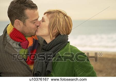 Couple Kissing on a beach Autumn Fall View Large Photo Image Stock Photo - Couple Kissing on a beach Autumn Fall. Fotosearch