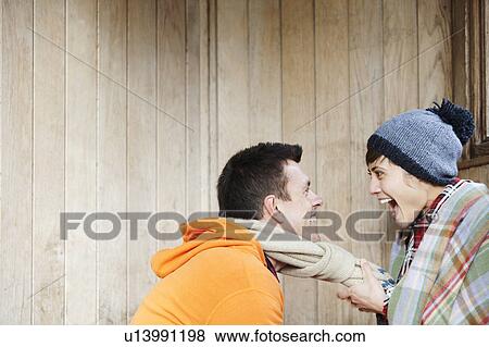 Couple laughing in a hut in the park View Large Photo Image Stock Photo - Couple laughing in a hut in the park. Fotosearch