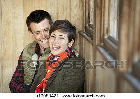 Couple laughing together in hut in park View Large Photo Image Stock Image - Couple laughing together in hut in park. Fotosearch